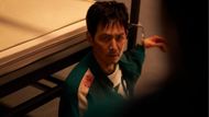 Gi-hun is handcuffed (Image Source: Instagram @squidgamenetflix)